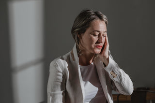 Mature woman with drooping eyelid and tired look